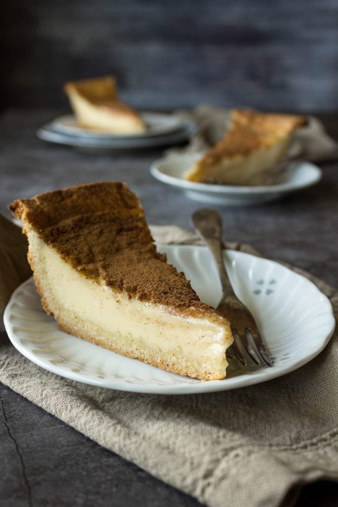 A creamy South African milk tart topped with cinnamon for a unique classic dessert.