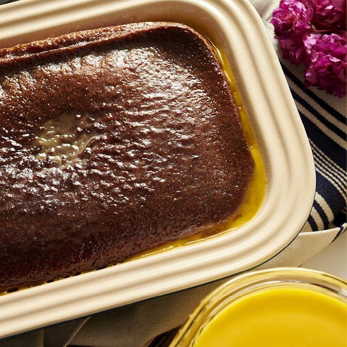 Delicious South African Malva Pudding drizzled with rich caramel sauce, a classic dessert perfect for any occasion.