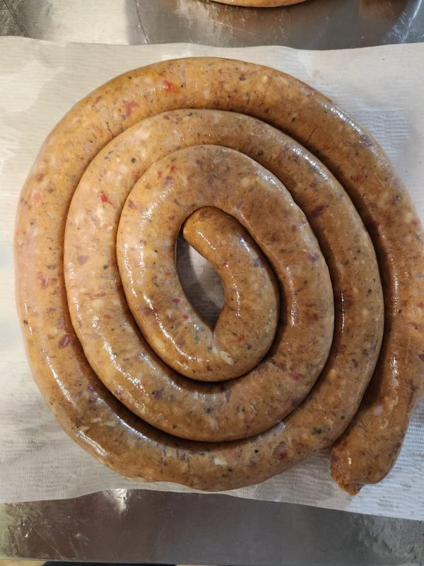 Fresh coiled Durban hot lamb sausage with visible chili and spice flecks