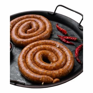 Raw Hot Masala Lamb Sausage coils on a black tray with red chilies, spicy boerewors inspired by South African Indian flavours