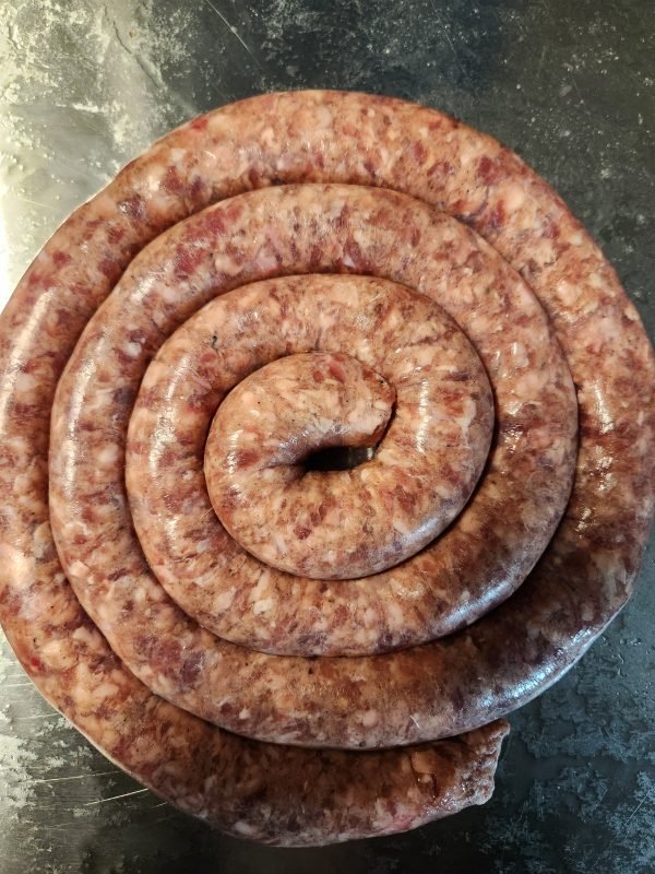 NetVleish Skaapwors Lamb Sausage coiled on a metal surface